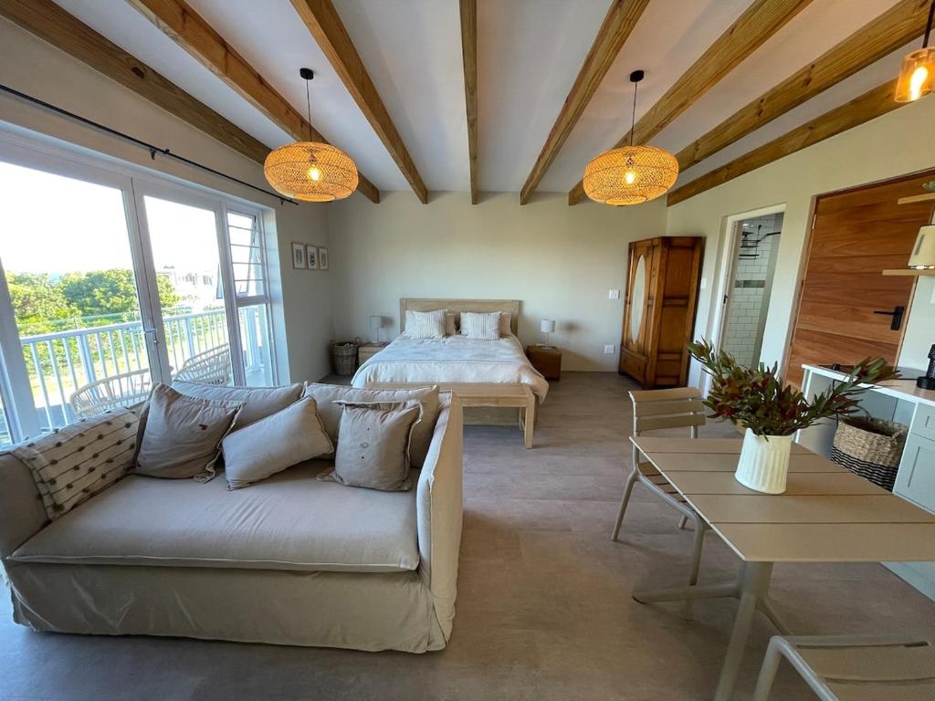 a living room with a bed and a couch at 2 Bedroom sea view studio in Onrus in Hermanus