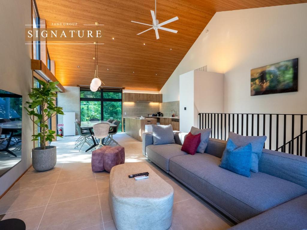 a living room with a couch and a table at Hakuba Amber Echoland MrT by Jade Villa in Hakuba