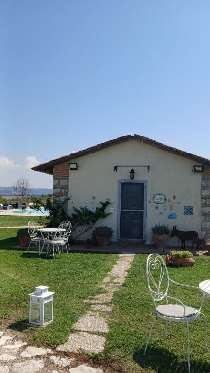 a group of chairs in front of a building at Country Relais La Torretta Baronale in San Giorgio Montagna