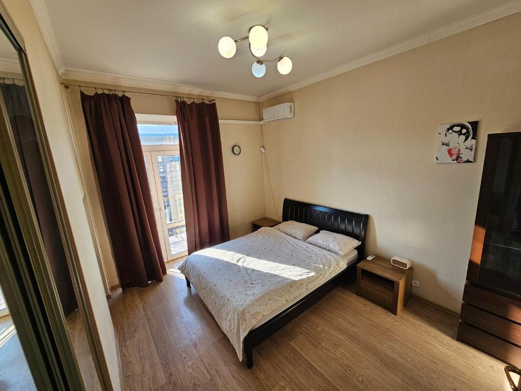 a small bedroom with a bed and a window at Майдан in Kyiv