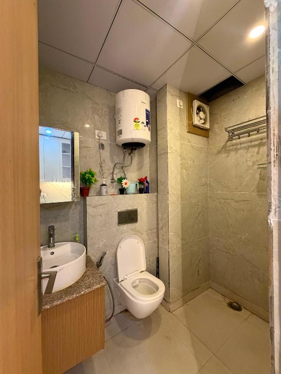 a small bathroom with a toilet and a sink at The heaven stay in Greater Noida
