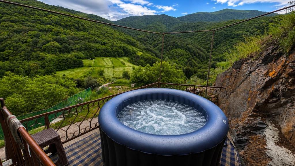 a large blue bath tub sitting on top of a balcony at Goshniver Rest House in Dilijan
