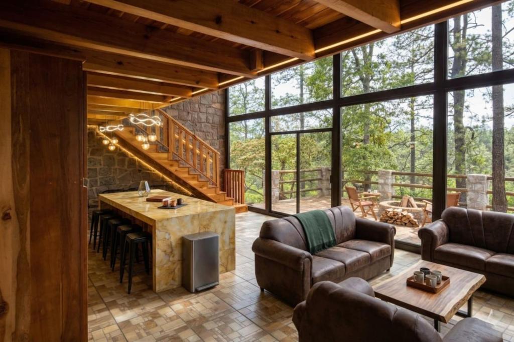 an open living room with a kitchen and a living room with furniture at Lujo Rustico Lago Cerca Terraza Mascotas in Llano Grande