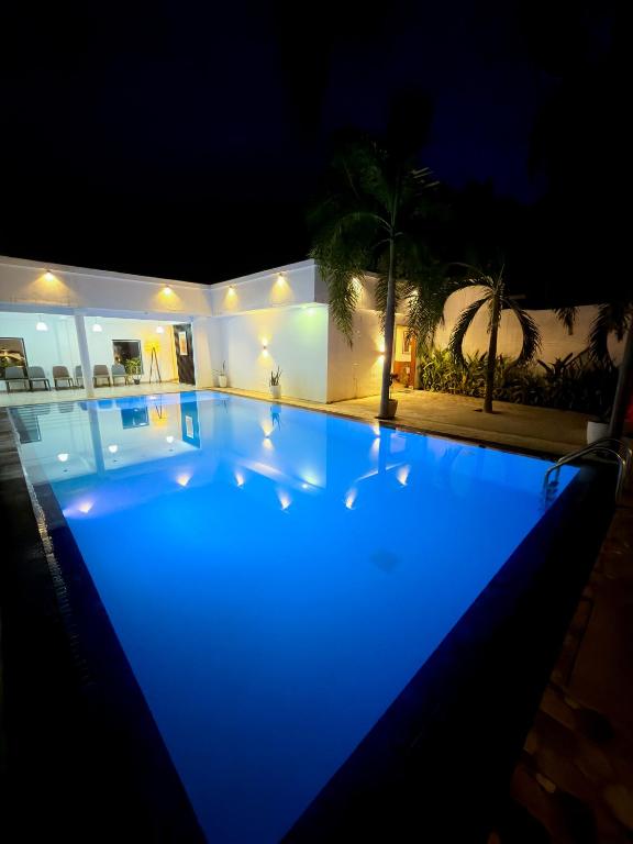 a swimming pool at night with blue lights at Lion Resort in Polonnaruwa