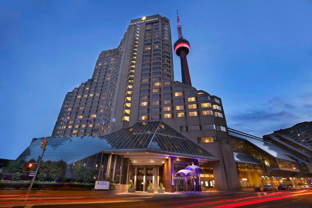 a large building with a flag on top of it at InterContinental Toronto Centre by IHG in Toronto