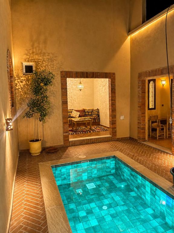 a swimming pool in the middle of a house at Hiking Nomads Guesthouse in Tamellalt