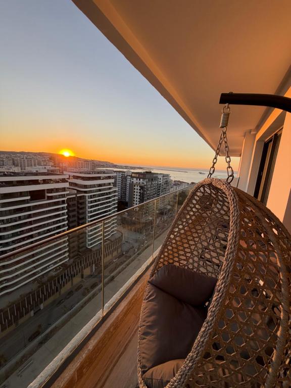 a hammock on a balcony with a view of the ocean at Triple Tower 23eme étage La vue 329 gare tgv & plage 3min in Tangier
