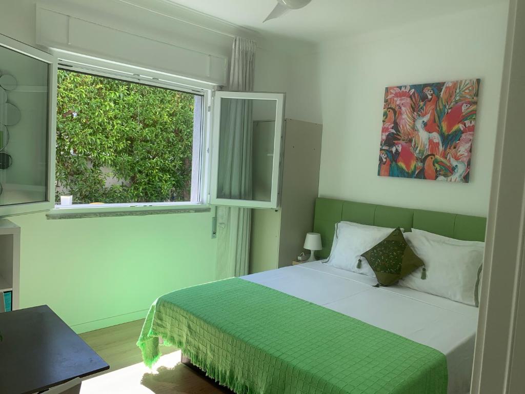 a bedroom with a large bed and a window at Ciao Tavira in Tavira