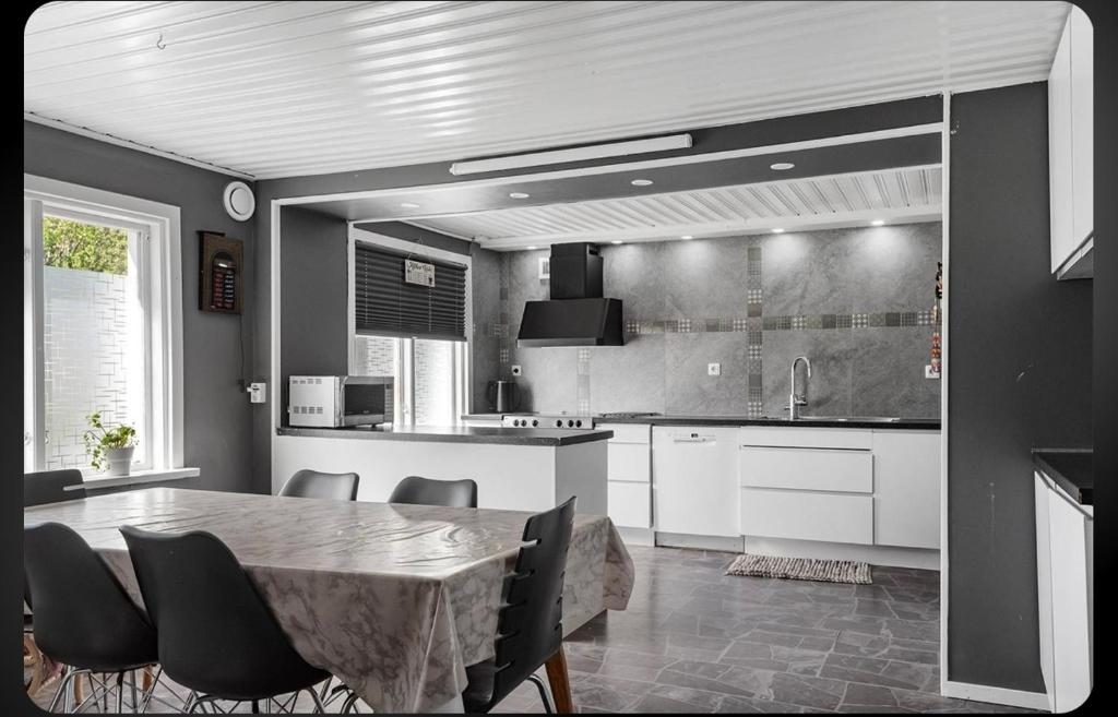 a kitchen with a table and chairs in a room at Shared room in a quiet area in Kallinge