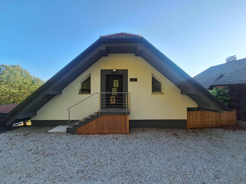 a small house with a staircase and a door at App TI-SA in Laze v Tuhinju
