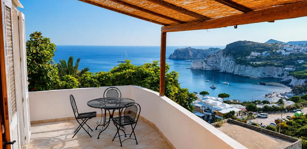 a balcony with a table and chairs and a view of the ocean at Maridea - La Marina in Ponza