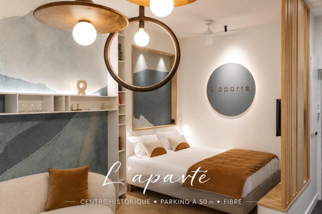 a bedroom with a bed and a chandelier at L'Aparté - Hypercentre Design & Parking in Albi