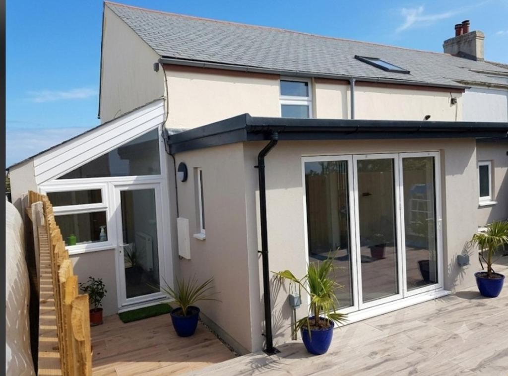 a extension to a house with sliding glass doors at Sam's retreat in Hayle