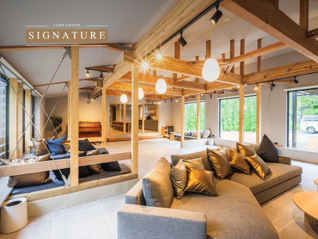 a large living room with a couch and a table at Tanglin Maison Hakuba by Jade Villa in Hakuba