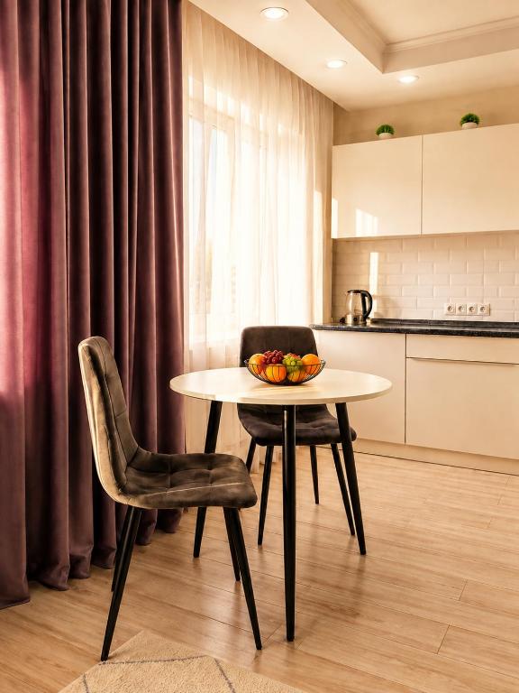 a table with a bowl of fruit on it in a kitchen at Студия Назарбаева 57 in Kokshetau