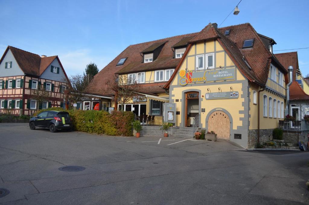 ein Gebäude mit einem Auto auf einem Parkplatz in der Unterkunft Hotel Sonneck in Schwäbisch Hall