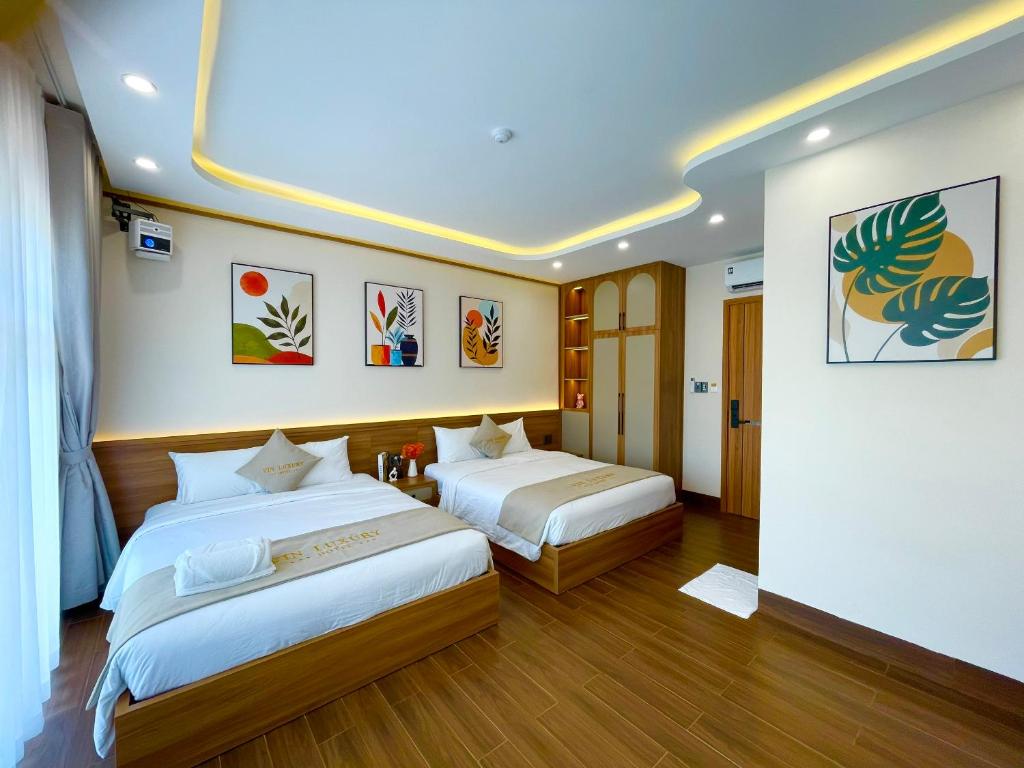 a hotel room with two beds in a room at Vin Luxury Hotel in Quang Tri