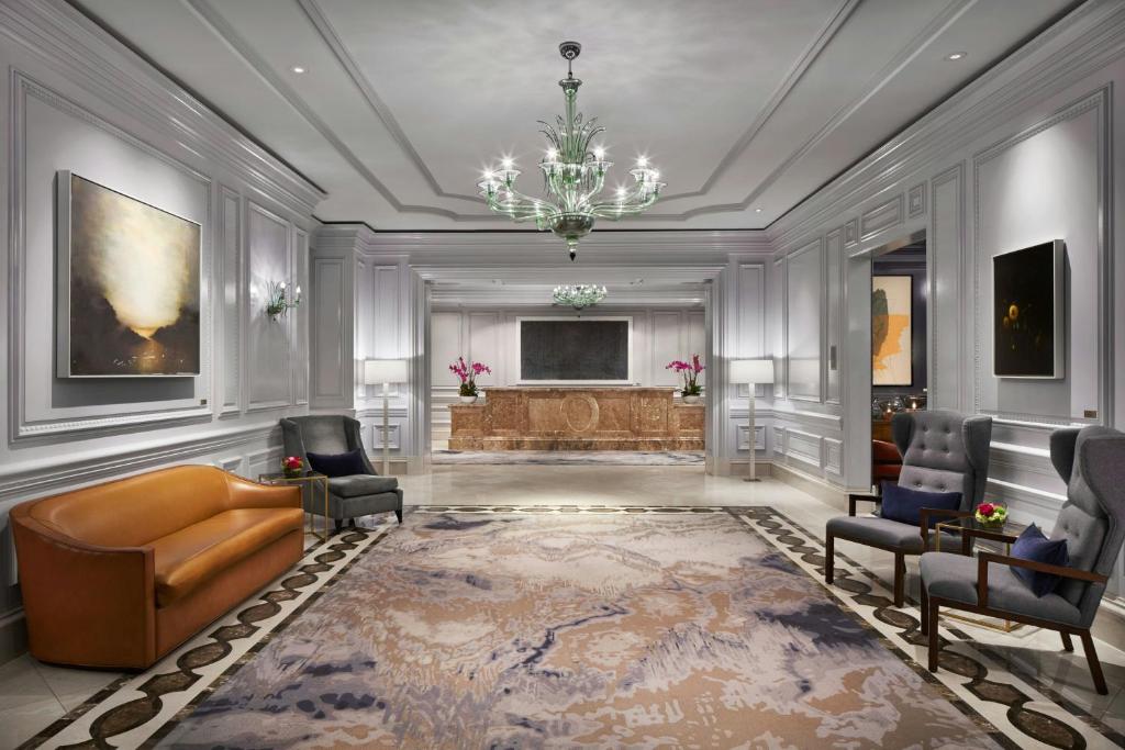 a living room with a couch and a television at The Ritz-Carlton, Washington, D.C. in Washington, D.C.