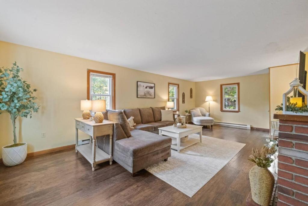 a living room with a couch and a table at Dog-Friendly Retreat, Fire Pit, Lakes Region in Gilmanton
