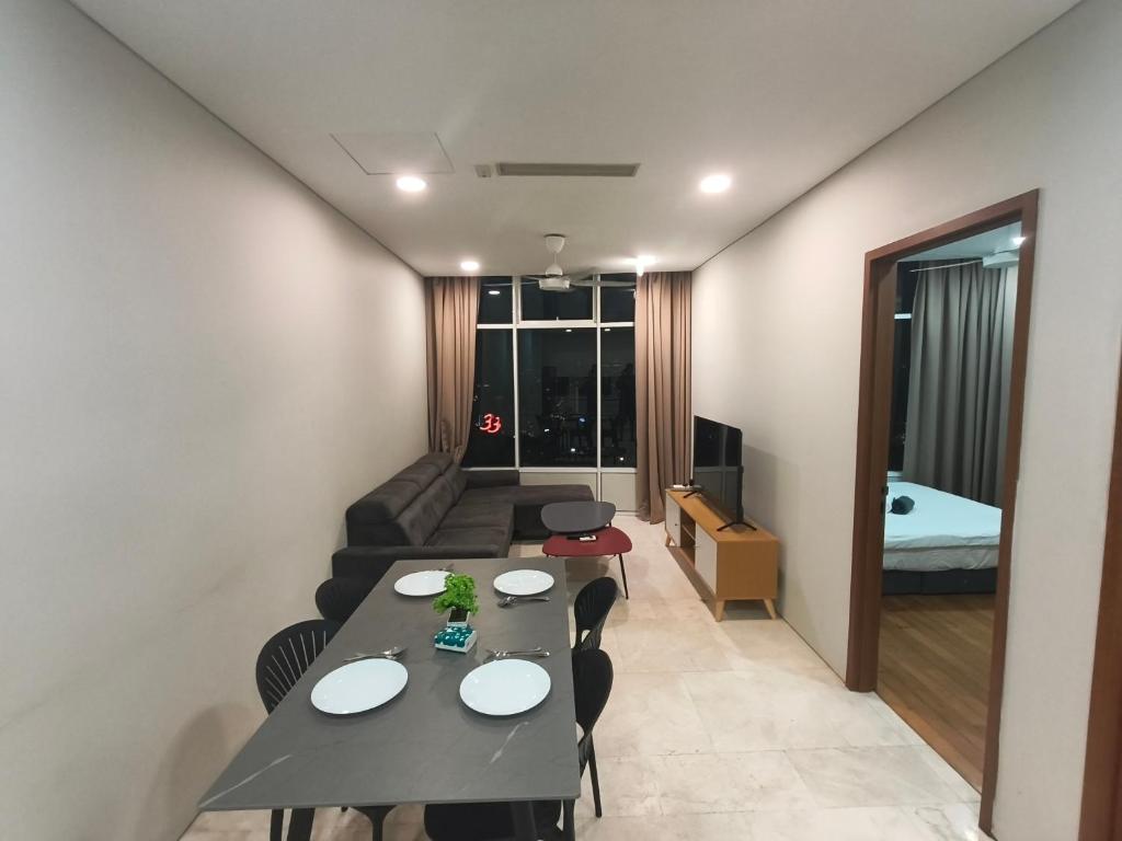 a room with a table and chairs and a couch at Klcc vortex runner in Kuala Lumpur
