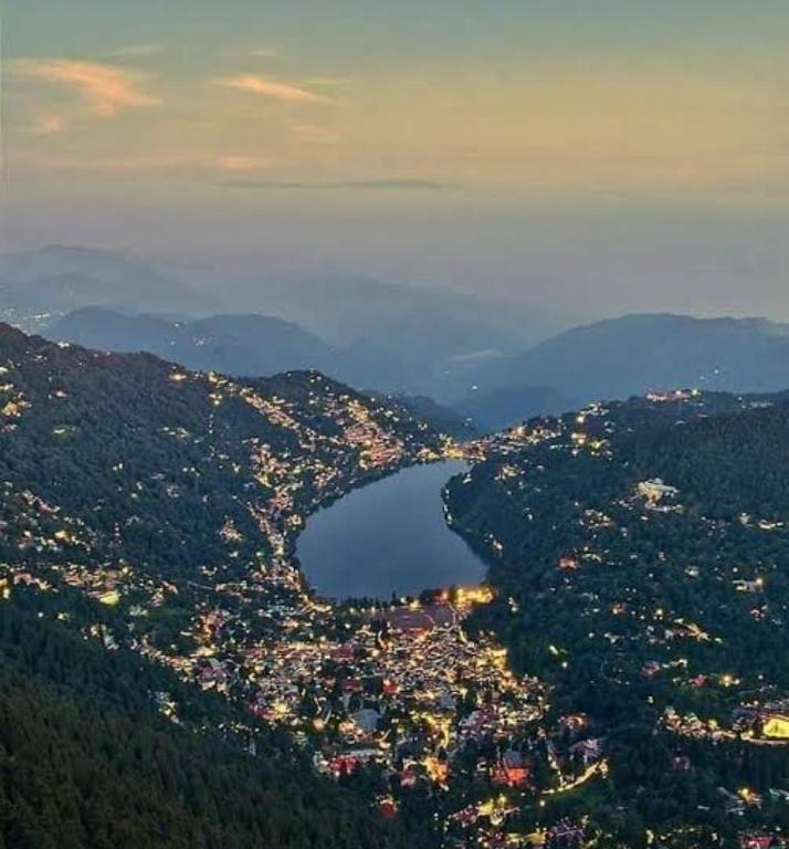 an aerial view of a city and a lake at Naini reflections in Nainital