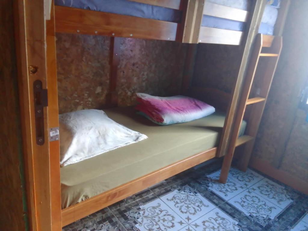 a bunk bed in a room with a pillow on it at Gite Chez Théo in Saint-Paul