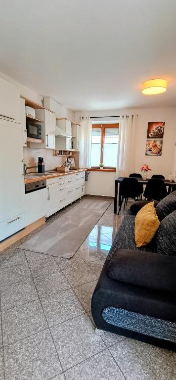 a kitchen and living room with a couch and a table at GADD Ferienwohnung 004 Glück an der Donau I Best Prestige Stay 24 h Check-In in Straubing
