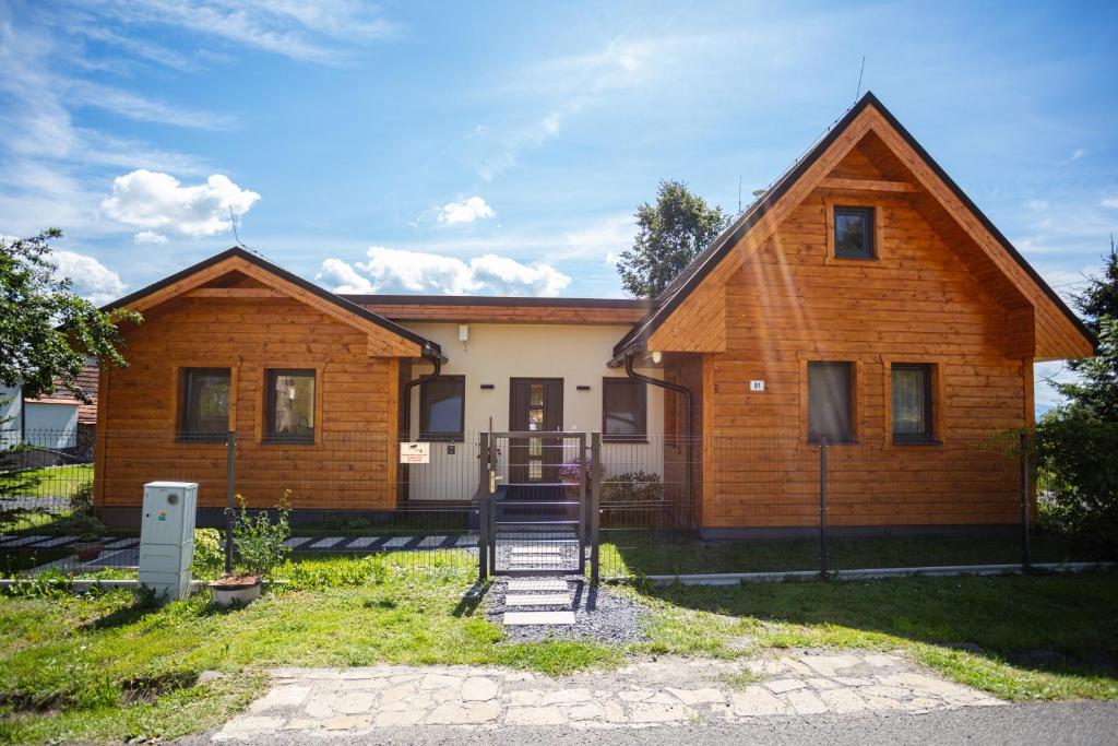 a house with a staircase in front of it at Drevenička Levanduľa in Liptovská Kokava