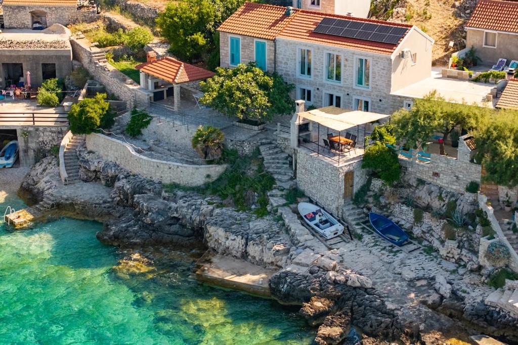 an aerial view of a house next to the water at Stone house Mia in Čara