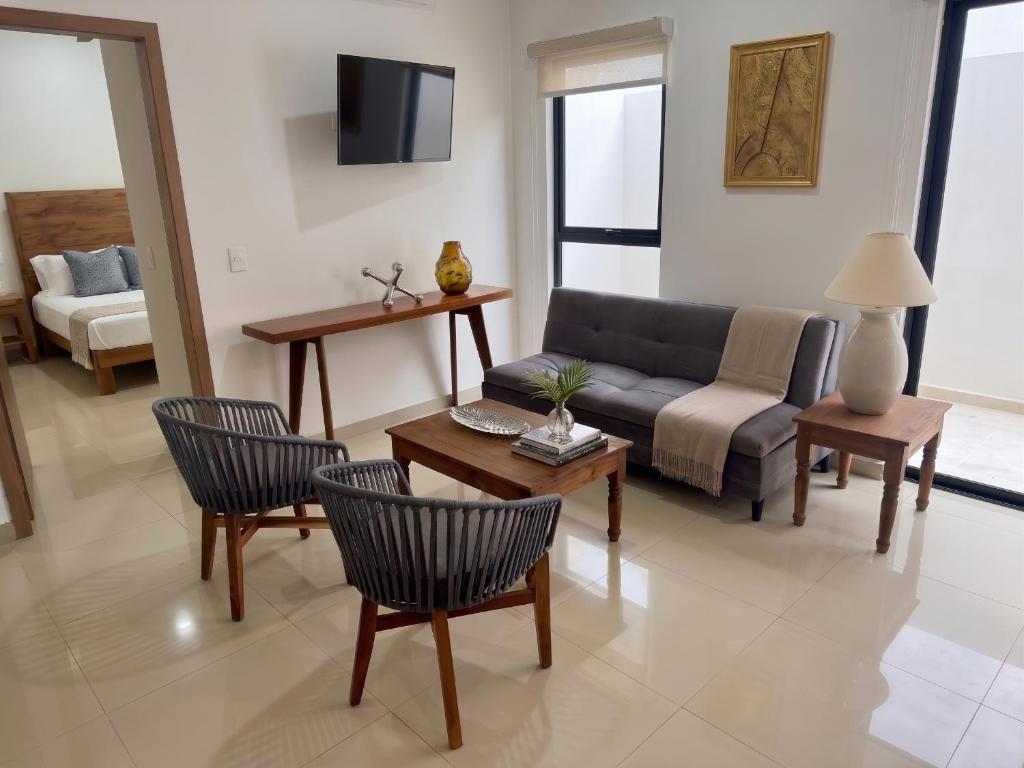 a living room with a couch and chairs and a table at 2br 1ba Condo 1 block to ocean Condo 1 in Mazatlán
