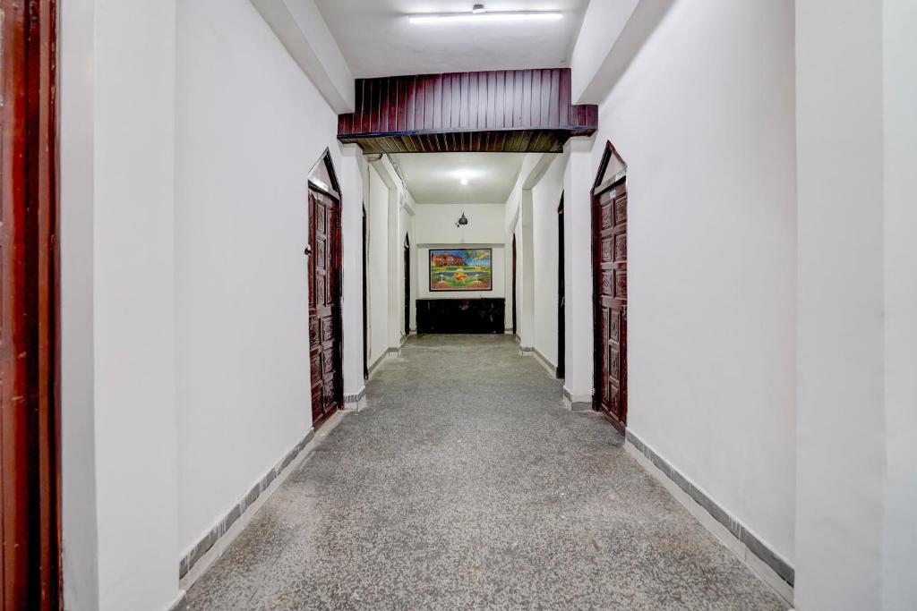 a corridor of a building with white walls and a hallway at Hotel O Vishal Residency in New Delhi