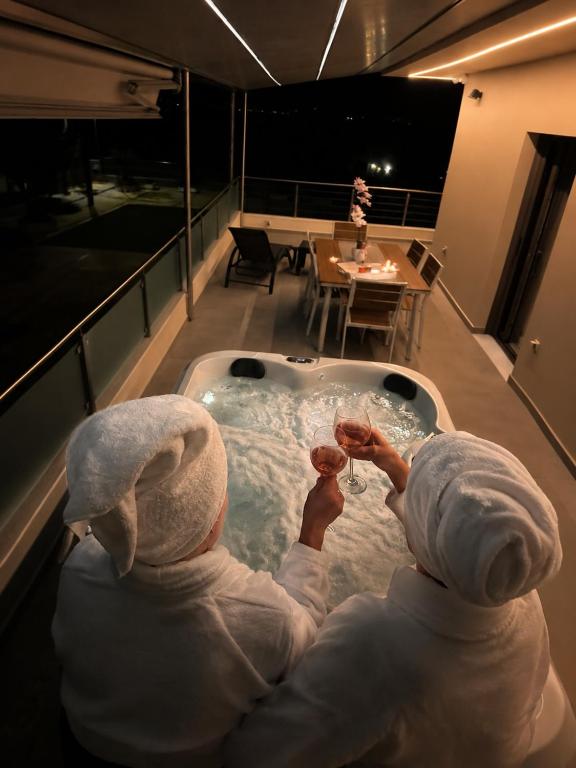 two children are sitting in a bath tub at AMORÉA Jacuzzi Suites Evia in Eretria