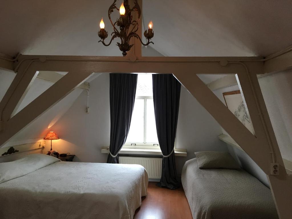 Postel nebo postele na pokoji v ubytování La Perle Apartment