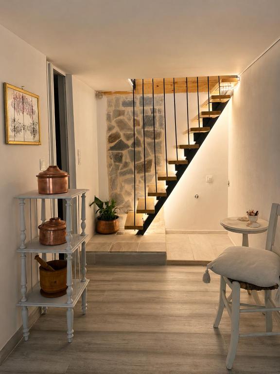 a living room with a staircase and a table at Lichno Spirit in Vourliótai