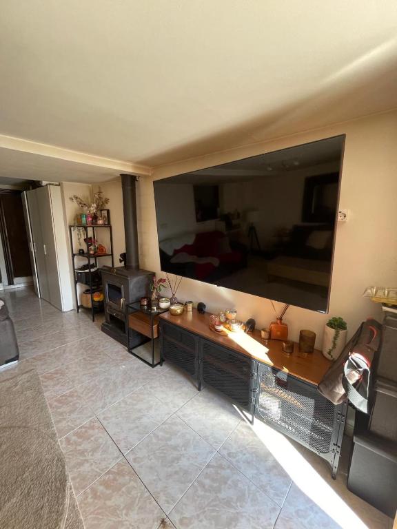 a large living room with a large flat screen tv at Los Marianos 