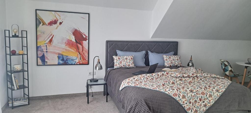 a bedroom with a bed with a laptop on it at Apartman Romansa in Fojnica