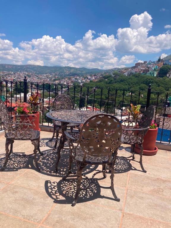 a table and chairs with a view of a city at Casa Granada in Guanajuato