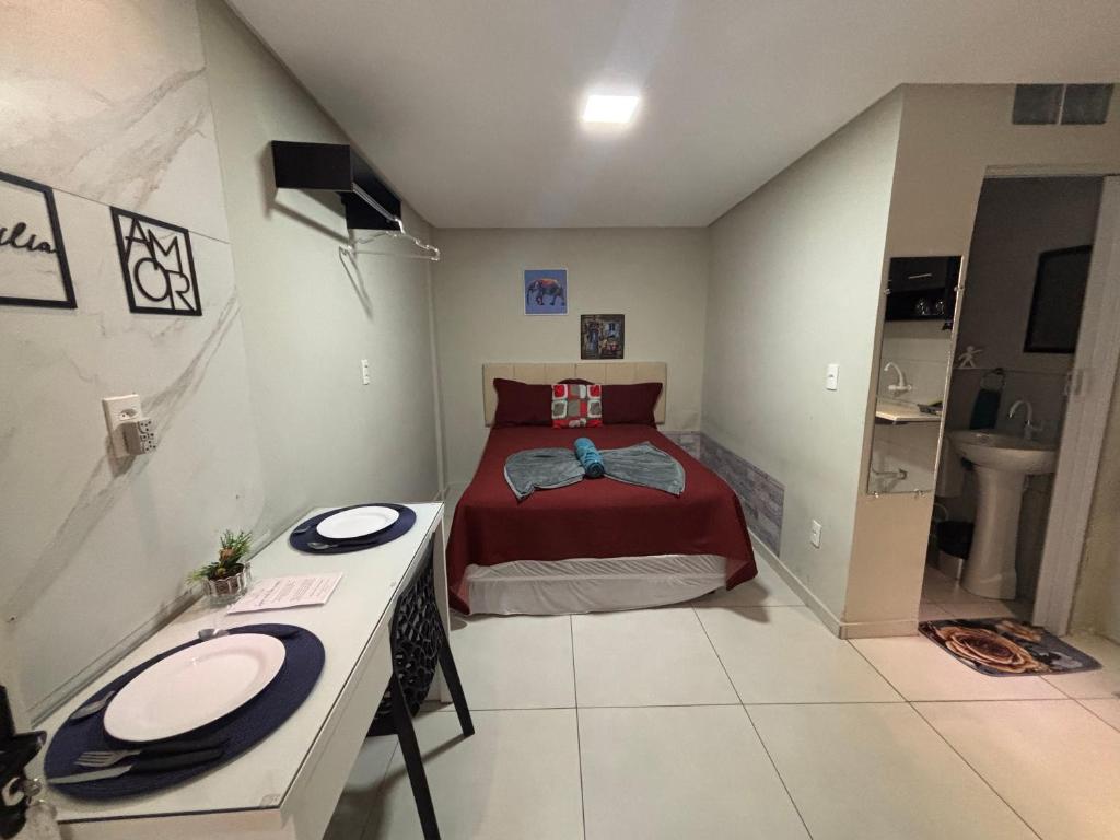a small bedroom with a bed and a sink at Flats 1778 N01 Orla de Petrolina in Petrolina