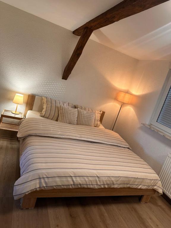 a bedroom with a bed with two lamps on it at Ferienwohnung mit Schminktisch 2OG in Gräfenhainichen