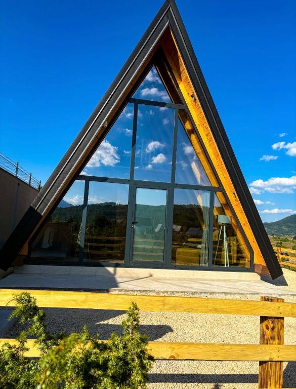 a frame house with a large window at Cottage Magdalena in Žabljak