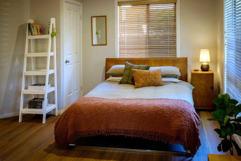 a bedroom with a bed and a book shelf at Simple Style Among the Gums 