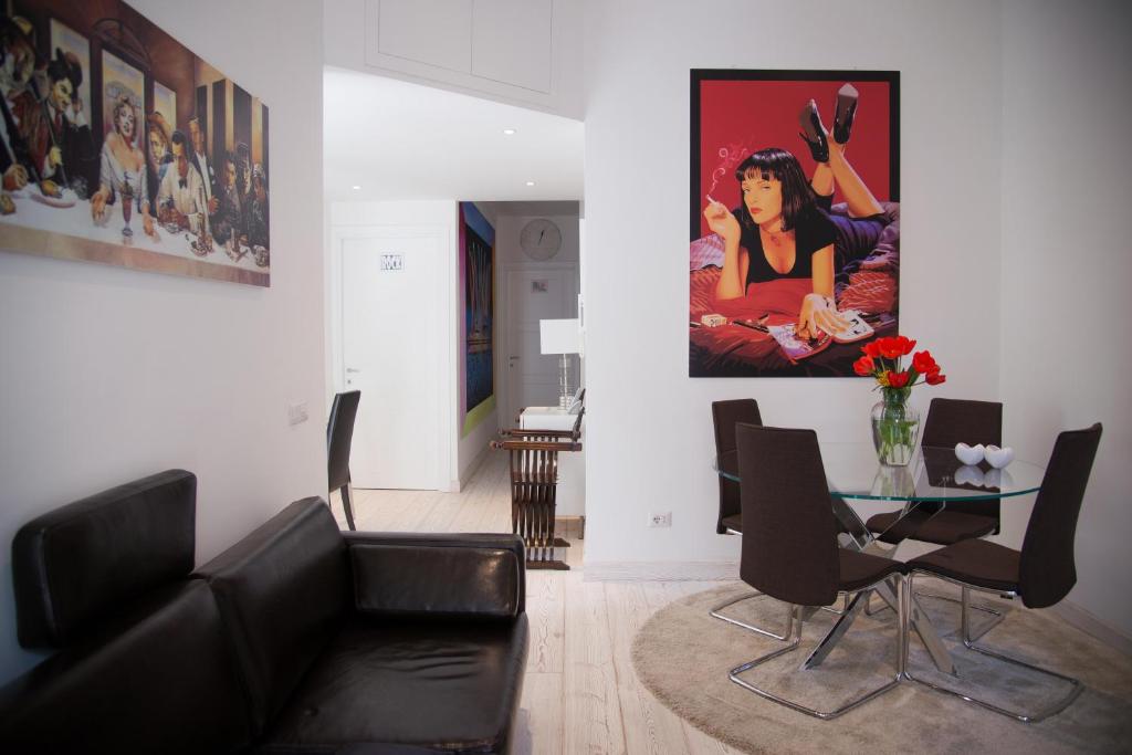 a living room with a black couch and a glass table at Big Johnny B in Rome