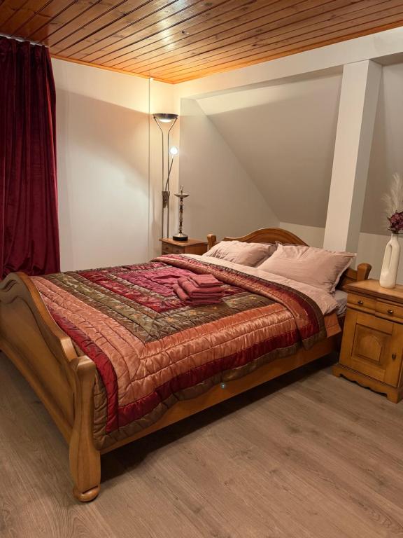 a bedroom with a bed and a lamp in it at Kalna Raskumu Apartamenti in Vecpiebalga