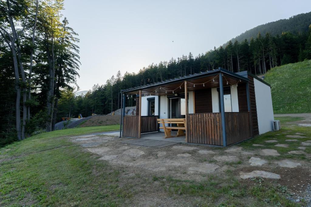 a small cabin with a picnic table in a field at Hiška pod vrhom in Poljane nad Škofjo Loko