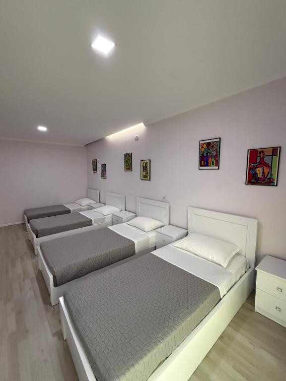 a room with four mattresses lined up against a wall at Prestige ESP ROOMS in Poliçan