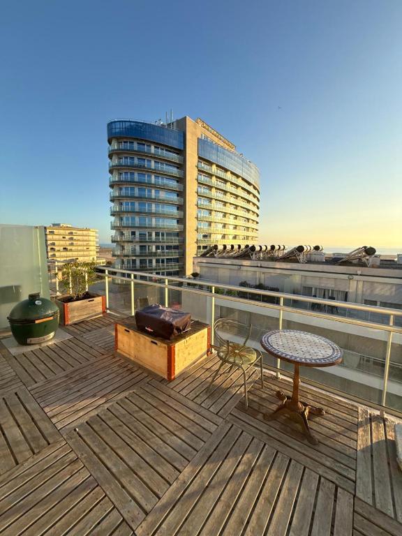 a deck with a table and a chair on a building at OASIS in Buarcos