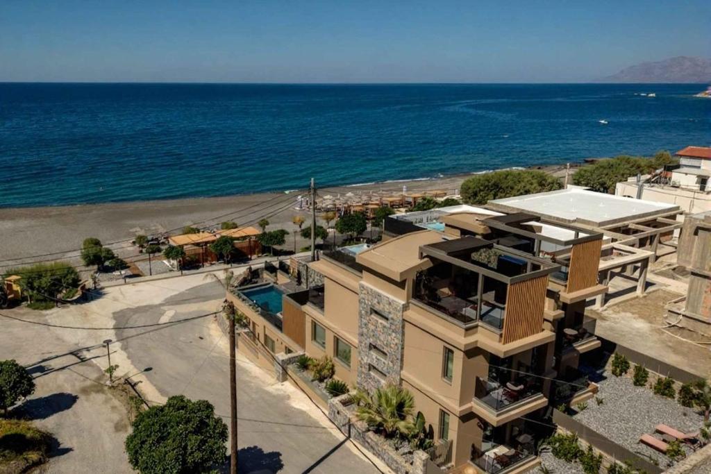 an aerial view of a building next to the ocean at Lapis Nera Villas - Beachfront & "Free" Heated Pools in Psari Forada