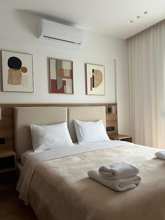 Posteľ alebo postele v izbe v ubytovaní Dhima Hotel