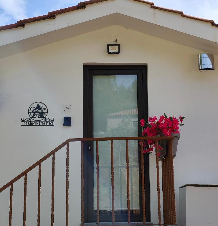 a building with a door and a flower pot on a balcony at The Cherry Tree Place in Góis
