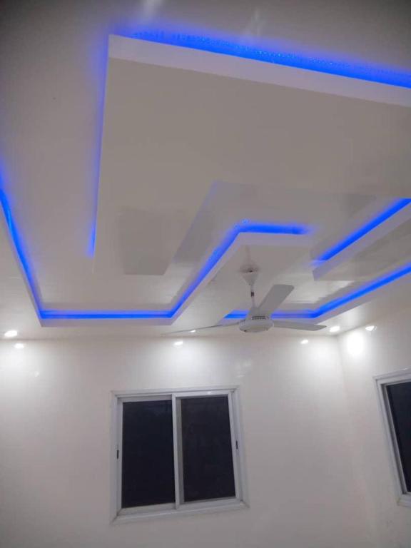 a white room with blue lights on the ceiling at Apartment Busumbala in Busumbala